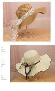 Detail of straw sun hats featuring wave scalloped edges and decorative bow ribbons