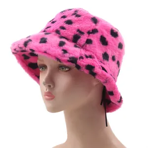 Plush faux fur bucket hat in pink with black leopard spots for winter warmth