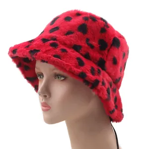 Detail of red faux fur bucket hat with leopard print showing plush texture and wide brim