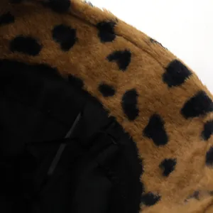 Close-up of leopard print faux fur texture and black fabric lining on the winter bucket hat