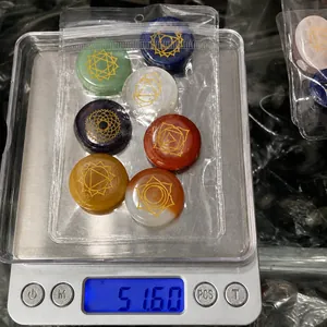 Detailed view of 7 chakra stones weighing 51.60g on a digital scale for DIY jewelry