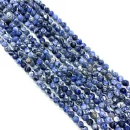Vue détaillée de perles rondes en pierre naturelle de 6mm à texture marbrée bleue