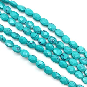 Close-up of faceted oval malachite green beads with natural black veined textures
