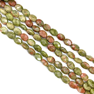 Macro view of faceted oval unakite stone beads showing natural green and pink textures