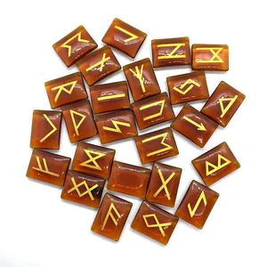 Detailed view of amber runes set with 24 engraved gold symbols on polished natural stones
