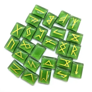 Macro shot of dark green rune stones with golden Elder Futhark engravings on white background