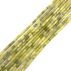 Detailed view of yellow-green cylindrical natural stone beads for DIY jewelry making