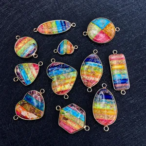 Macro detail of mixed geometric stone pendants with rainbow textures and gold metal frames