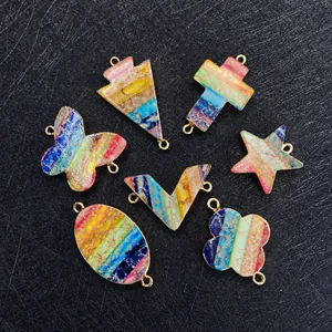 Macro shot of colorful imperial stone jewelry charms in heart and clover shapes