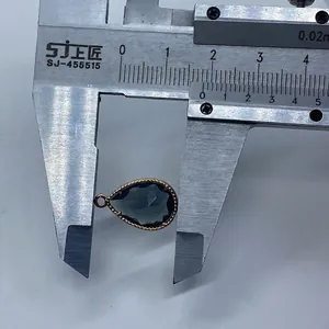 Detailed size measurement of the faceted teardrop gemstone pendant with a digital caliper