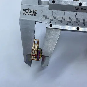 Detail shot of a faceted crystal pendant being measured with a metal caliper tool