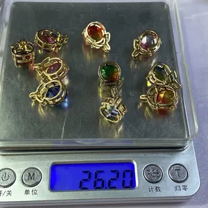 Detailed scale view of nine faceted crystal pendants showing a total weight of 26.20 grams