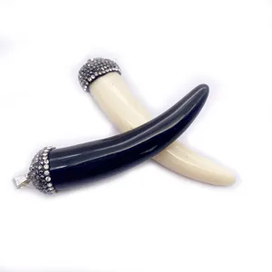 Pair of black and cream resin cornicello horn pendants with rhinestone encrusted caps