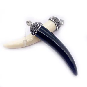 Polished black and white resin ox bone chili pendants with pavé crystal metal caps