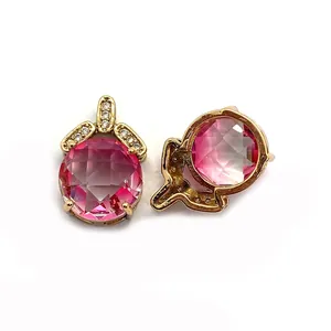 Detailed view of faceted pink crystal stud earrings with gold plating and zircon accents