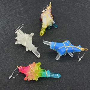 Detailed wire-wrapped natural crystal pendants in various colors on black background