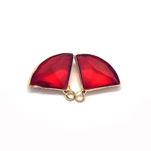 Macro detail of red faceted stones in fan shapes with golden metal edges for jewelry DIY