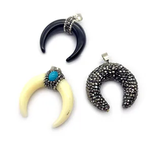 Three crescent moon resin pendants in black, cream, and charcoal grey with rhinestone accents