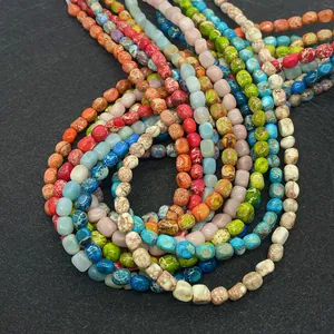 Close-up of irregular natural emperor stone beads with colorful marble textures for DIY jewelry
