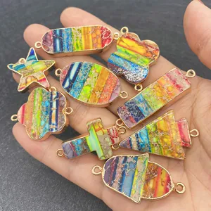 Detailed macro view of gold plated rainbow jasper stone connectors in various shapes