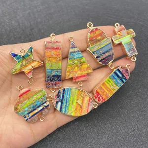 Detail of colorful stone connectors in star and oval shapes with gold metal edges