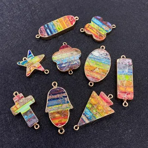 Detailed view of colorful star and cross gemstone connectors with gold-plated edges