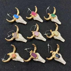 Detail of steer skull pendants with colorful druzy stones and gold horns for DIY jewelry