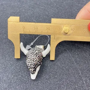 Macro shot measuring 32mm wide bull head pendant with dark grey rhinestones