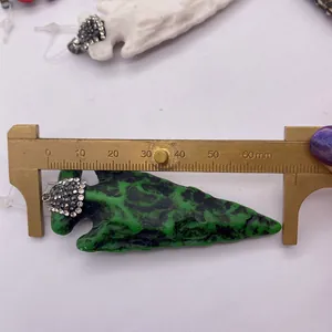 Mesure du pendentif flèche en résine verte avec strass indiquant 55 mm de long