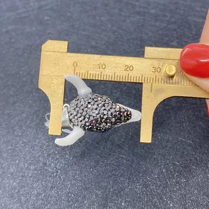 Close-up of acrylic bull head pendant with grey rhinestones measuring about 30mm on calipers