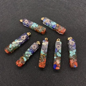Macro view of rectangular resin pendant with colorful natural stones and metal spiral