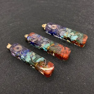 Macro view of three resin pendants with natural crushed stones and copper wire spiral