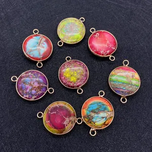 Flat lay of colorful 21x30mm round imperial stone pendants with double-hole gold connectors