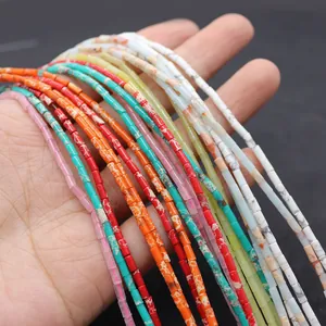 Macro view of 2x4mm cylindrical natural emperor stone beads in vibrant assorted colors