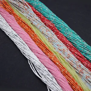 Close-up of colorful tube-shaped Heishi beads with marble texture for DIY jewelry
