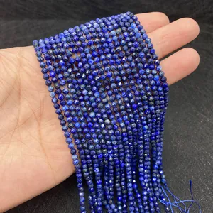Macro shot of natural lapis lazuli faceted beads held in hand for DIY jewelry making