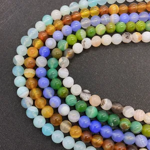 Macro view of polished colorful natural silk agate round beads with unique textures