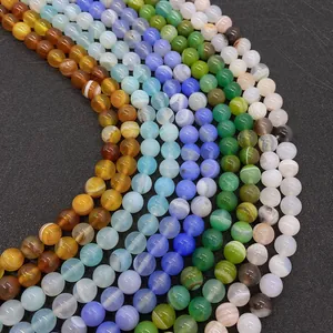 Detailed view of polished 8mm blue silk agate round beads with natural striped texture