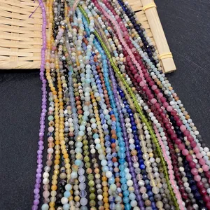 Macro view of multi-colored faceted 2-3mm natural stone beads on a bamboo tray