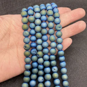 Macro detail of matte blue-gold gradient agate beads with natural druzy crystal texture