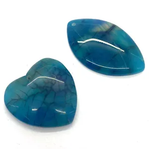 Detailed macro view of heart and marquise blue agate pendants with icy texture and pre-drilled holes