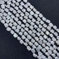 Macro shot of irregular baroque freshwater pearls with silver-white luster for DIY jewelry