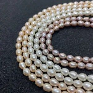 Gros plan de perles d'eau douce naturelles AAA ovales en blanc, champagne et violet