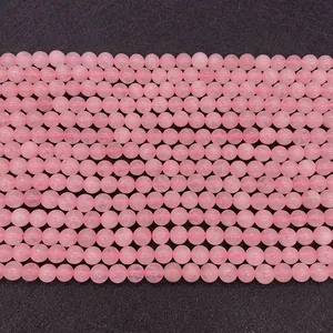 Macro detail of natural pink rose quartz round beads with smooth polished finish
