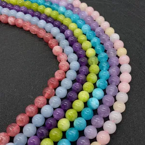 Perle tonde in pietra naturale 6mm-10mm lucide disposte in un arco multicolore