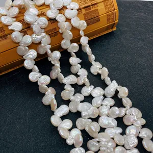 Baroque button freshwater pearls for DIY jewelry displayed on a vintage bamboo mat