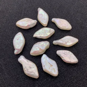 Macro shot of 10 baroque freshwater pearls with rainbow luster on a black textured base