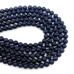 Perles rondes en grès bleu scintillant pour création de bijoux sur fond blanc