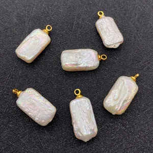 Detail of six rectangular baroque freshwater pearl pendants with gold loops on black