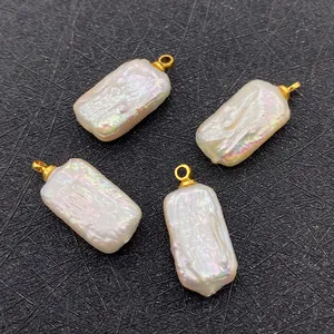 Detailed macro of four rectangular baroque freshwater pearl pendants with gold loops